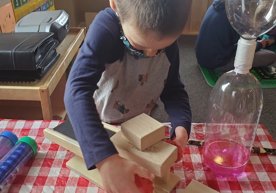 Little boy playing with building blocks.